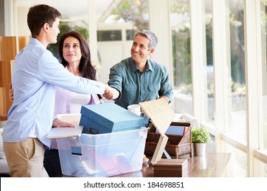 Parents Helping Teenage Son Pack For College