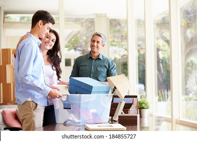 Parents Helping Teenage Son Pack For College