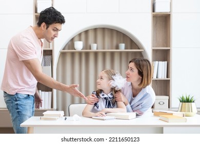 Parents Helping Their Daughter With Lessons And Homework. Mother Protecting Her Child From Angry Father Who Is Going To Hit Her. Punishment And Education Concept