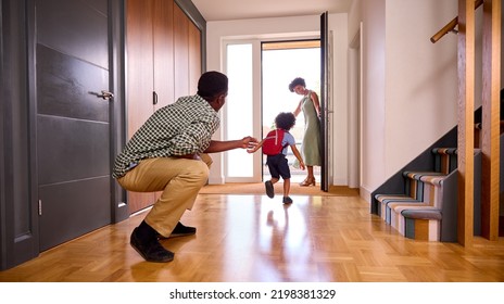 Parents At Home Helping Son Getting Ready To Go To School - Powered by Shutterstock