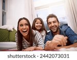 Parents, kid or floor to play, love or smile in comic, relax or silly as bonding together in home. Young family, ground or laugh to joke, embrace or care as playful, funny or goofy holiday break