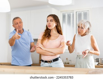 Parents lecturing their adult daughter at home - Powered by Shutterstock