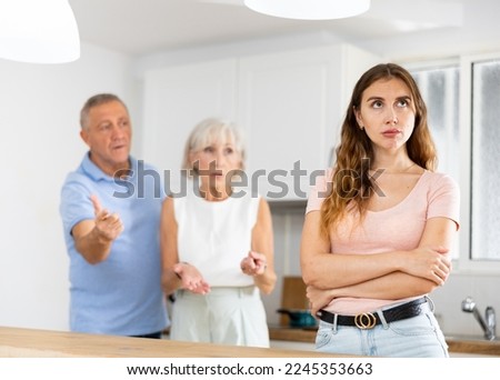 Parents lecturing their adult daughter at home