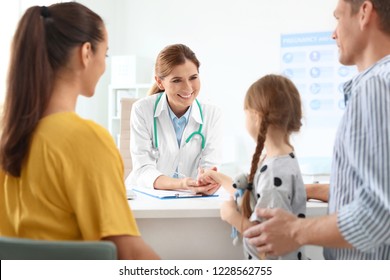 Parents with little daughter visiting children's doctor in hospital