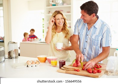 Parents Preparing Family Breakfast In Kitchen - Powered by Shutterstock