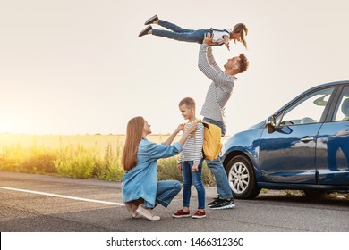 Parents Saying Goodbye To Their Children Near Car