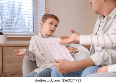 Parents scolding their little son for F grade at home - Powered by Shutterstock