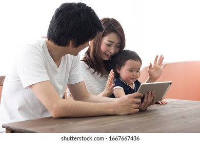 Parents Showing Tablet To Child