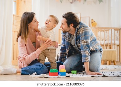 Parents take care of child. Little small crying shouting baby child kid infant toddler newborn feeling hungry, needs to change diapers, suffering from colics and teething. Parenthood