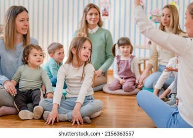 Parents taking part in the activities for preschool children. Healthy learning environment. Teacher and parents working together. - Shutterstock ID 2156363557