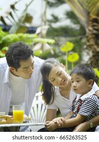 parents talking to their son while having breakfast - Shutterstock ID 665263525