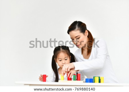 Parents are teaching children to do homework.