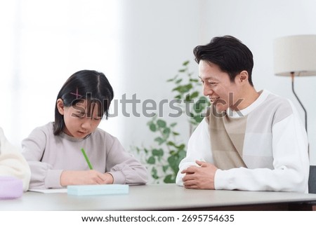 Parents teaching their child to study