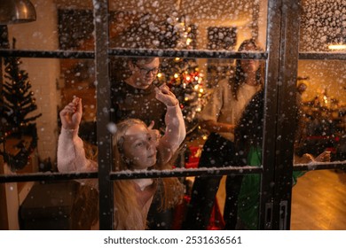 Parents and a teen girl dancing happily on Christmas night with the first snowfall - Powered by Shutterstock