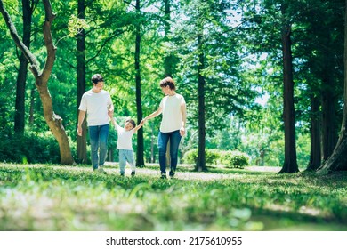 Parents and their child exploring the woods