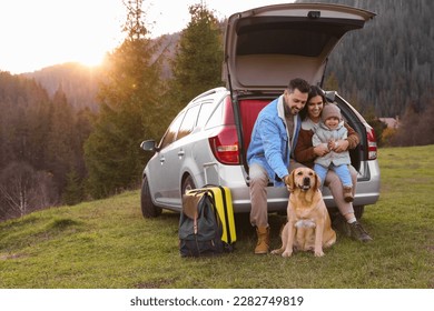 Parents, their daughter and dog near car in mountains, space for text. Family traveling with pet - Shutterstock ID 2282749819