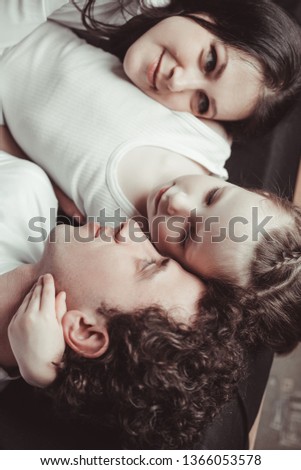 Similar – Image, Stock Photo Man reading with wife and son sleeping
