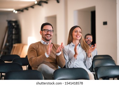 Parents Watching The Performance Of Their Child In School Play. Audience Applauding, Front View.