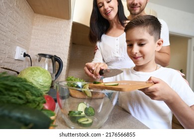 Parents Watching Their Kid Making Vegetable Salad