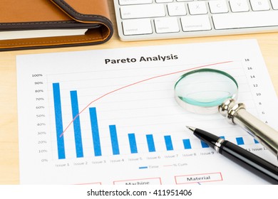 Pareto principle business analysis planning with pen, magnifier, and keyboard