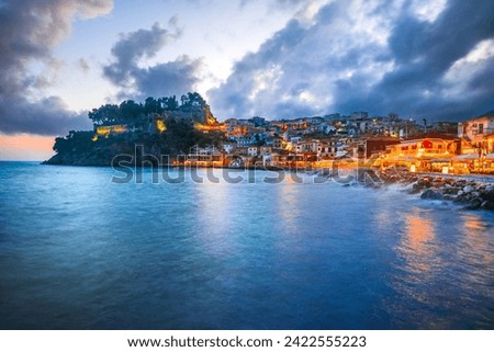 Parga, Greece. Beautiful colorful coastal town in Epirus, Greek holidays. Blue hour sunset illuminated oldtown.