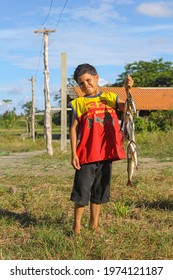 Parintins, Amazonas, Brazil - March 20, 2012: Boy Showing The Fish He Managed To Catch On His Fishing Trip, And He Will Take Them To His Family For Lunch.