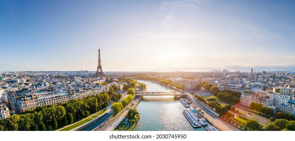 Paris aerial panorama with river Seine and Eiffel tower, France. Romantic summer holidays vacation destination. Panoramic view above historical Parisian buildings and landmarks with blue sky and sun - Shutterstock ID 2030745950