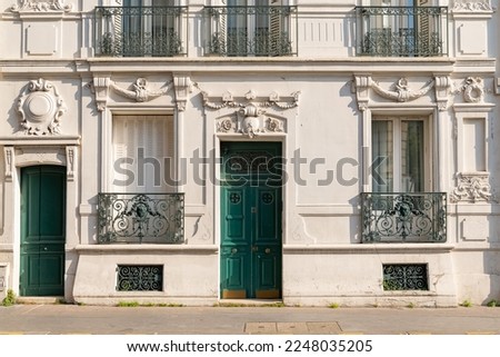 Paris, an ancient wooden door, beautiful facade in the 11e arrondissement