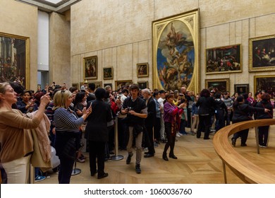 PARIS - APRIL 2, 2018: Crowd Of The Unidentified People Take Pictures Of The Mona Lisa In Louvre,  Portrait Painting By  Leonardo Da Vinci  In Paris, France