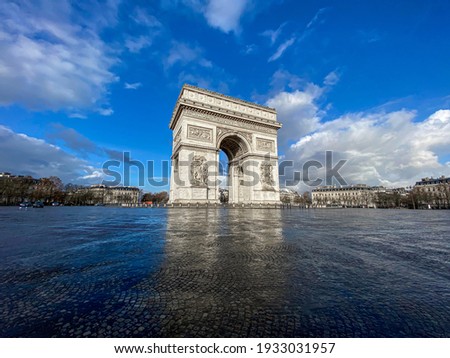 Paris, arc de triomphe during a sunny and cloudy day
