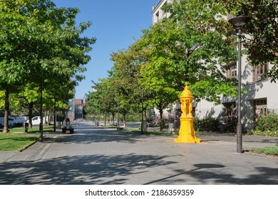 Paris - August 01 2022 : Small Urban Park With A Yellow Fountain 