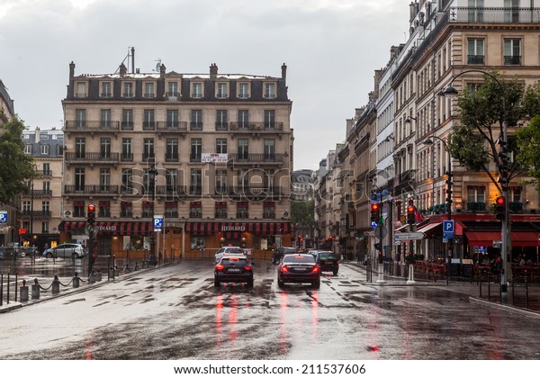 PARIS - AUGUST 03: rue de Seze at the church La\
Madeleine on a rainy day on August 03, 2014 in Paris. Paris is the\
largest city in France and one of the most important cities of the\
western world.