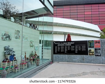 Paris, August 27: A Souvenir Shop Display Next To The Museum Called 'musee Du Quai Branly - Jacques Chirac' At Dusk, France 2018.