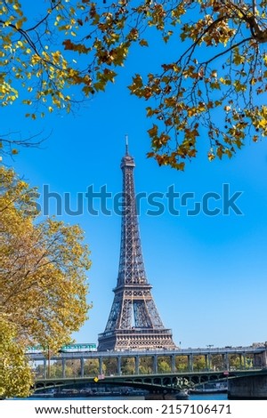 Similar – Eiffel Tower in green trees on blue sky