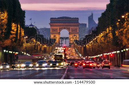 Paris, Champs-Elysees at night. Car traffic jam on street near Arc de Tripmphe. pollustion concept or stop diesel fuel for the environment. save the planet Earth. France