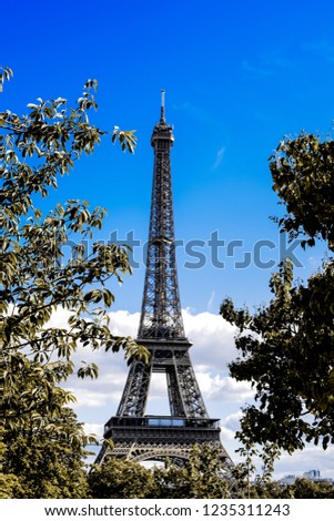 Similar – Eiffel Tower in green trees on blue sky