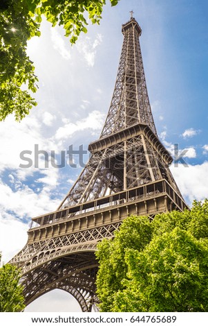 Similar – Eiffel Tower in green trees on blue sky