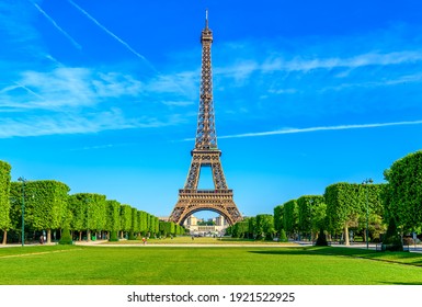Paris Eiffel Tower and Champ de Mars in Paris, France. Eiffel Tower is one of the most iconic landmarks in Paris. The Champ de Mars is a large public park in Paris - Shutterstock ID 1921522925