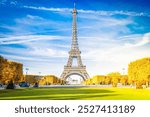 Paris Eiffel Tower over green grass lane in Paris, France. Eiffel Tower is one of the most iconic landmarks of Paris at fall