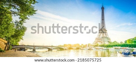 Paris Eiffel Tower reflecting in river Seine at sunrise in Paris, France. Web banner format. Eiffel Tower is one of the most iconic landmarks of Paris, web banner format