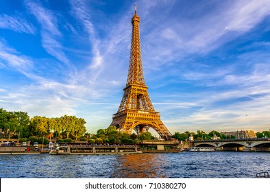Paris Eiffel Tower and river Seine at sunset in Paris, France. Eiffel Tower is one of the most iconic landmarks of Paris. - Shutterstock ID 710380270