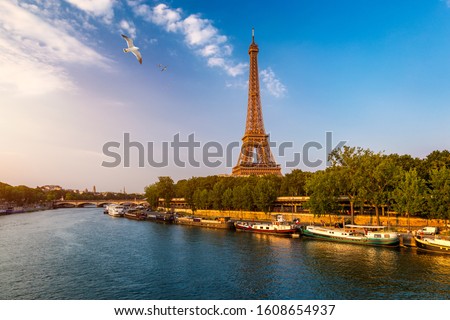 Paris Eiffel Tower and river Seine at sunset in Paris, France. Eiffel Tower is one of the most iconic landmarks of Paris. Eiffel tower in summer, Paris, France. 