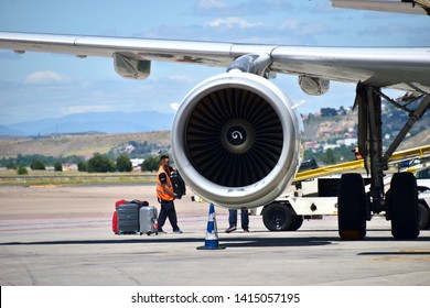 Paris / France - 06 04 2019: Close Up On The Propeller Of An Airliner Plane With Airport Employees Loading Passenger's Luggages