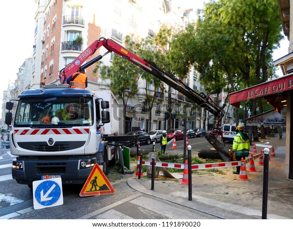 Paris, France - 09/30/2018: a\
truck loads the trunk of a fallen tree rue Caulaincourt,\
Montmartre