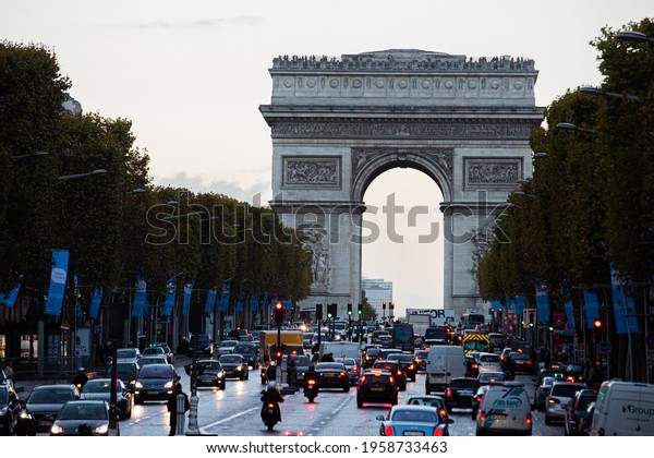 Paris, France, 1.11.2019 - evening car Traffic jam\
on Champs Elysees with view of Arc de Triomphe. Travel Greeting\
Card from Paris with love. Monument commemorating victories of\
Napoleon\'s army