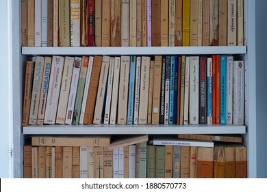 PARIS, FRANCE -15 DEC 2020- View Of A Bookshelf Filled With Miscellaneous Used Vintage Paperback Books In French.