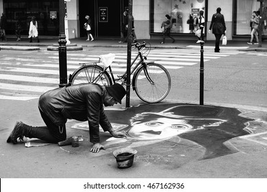 Paris, France - 17 September, 2015: :Artist during drawing Charlie Chaplin on sidewalk near Centre Georges Pompidou in Paris. Black and white.