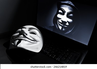 Paris - France - 18 January 2015 - Vendetta mask on computeur with an anonymous member on screen, . This mask is a well-known symbol for the online hacktivist group Anonymous 