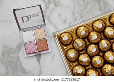 PARIS, FRANCE - 20 JUNE 2018: A Pallet Of Dior Backstage Glow Face & Box Of Ferrero Rocher. Dior Is A European Luxury Goods Company With Revenues Of $41.6 Billion & Almost 85,000 Employees. Editorial.