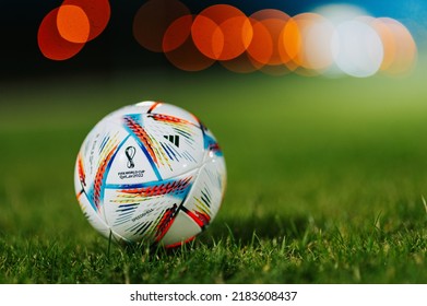 PARIS, FRANCE, 26. MAY, 2022: Original Adidas Football Ball For FIFA World Cup 2022 In Qatar. Ball On Green Grass. Bokeh Light In Background